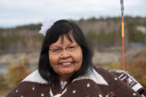 smiling middle-aged woman with glasses and dark hair